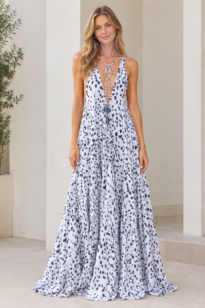 Front view of model wearing white dotted sleeveless plunge neck maxi dress