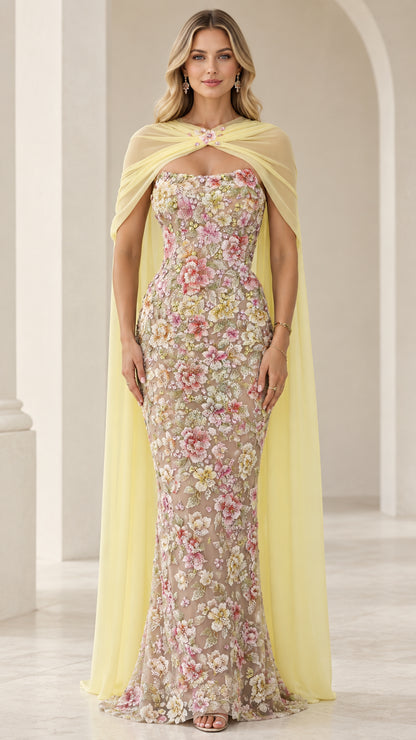 Pastel yellow floral embroidered strapless evening gown with sheer chiffon capelet front view