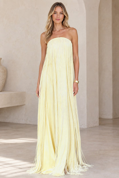 Front view of model wearing butter yellow strapless fringe maxi dress