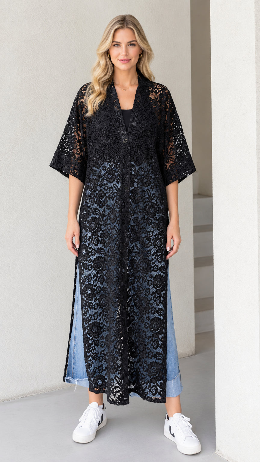 Full front view of model wearing black sheer floral lace maxi duster cardigan with jeans and sneakers