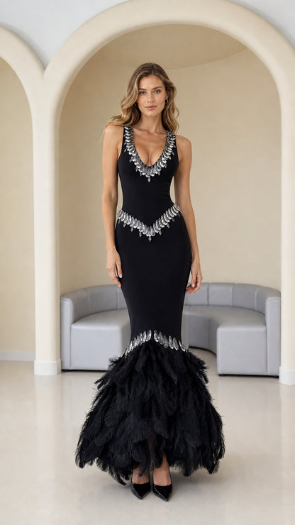 Front view of black sleeveless mermaid evening gown with rhinestone trim and feather hem