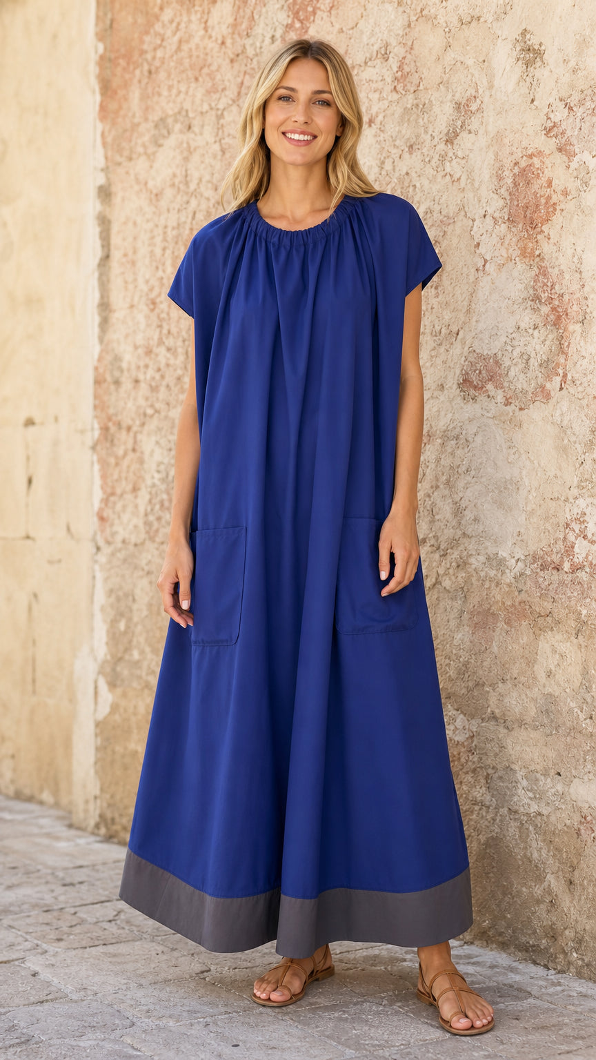 Full-length front view of model wearing Royal Blue gathered neck maxi dress with grey hem