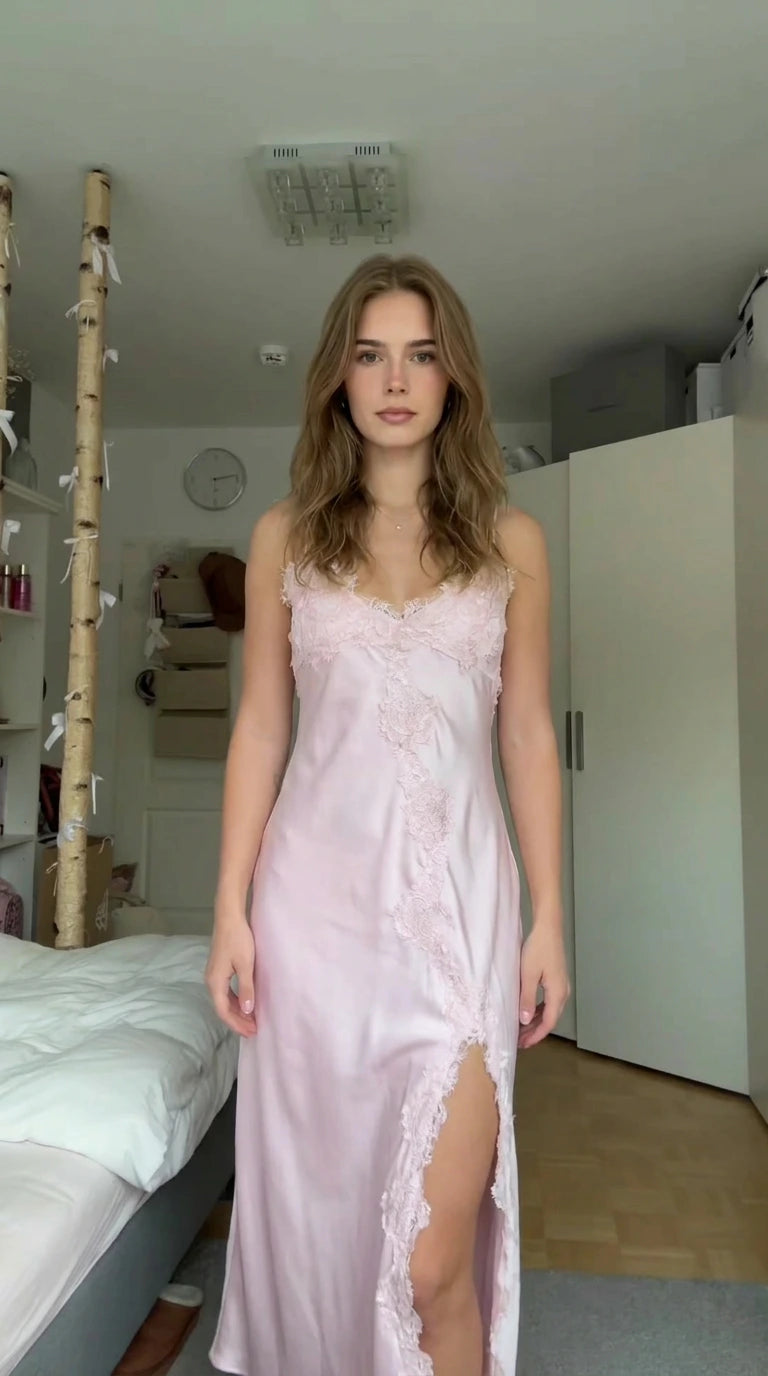 Front view of model wearing light pink satin maxi slip dress with lace trim and high slit