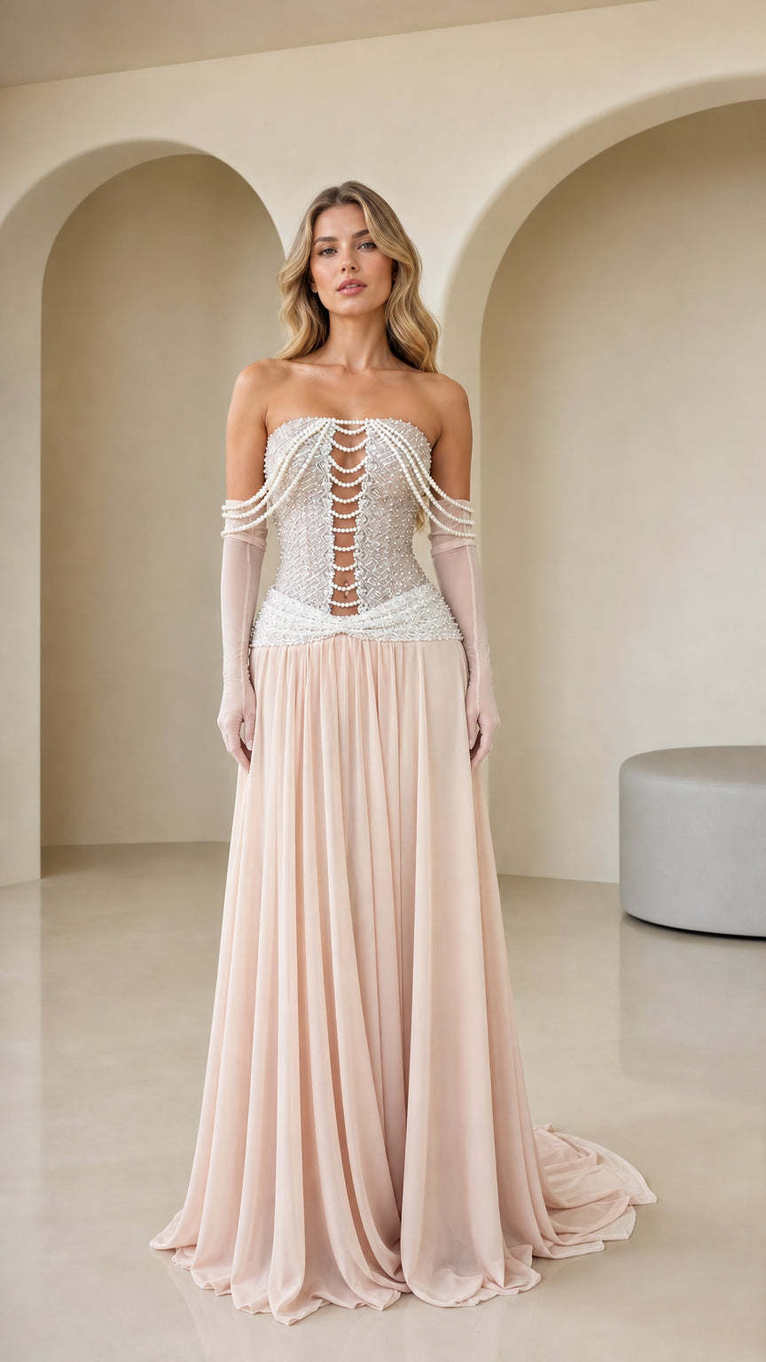 Front view of Blush Pink strapless evening gown with pearl corset bodice and flowing chiffon skirt