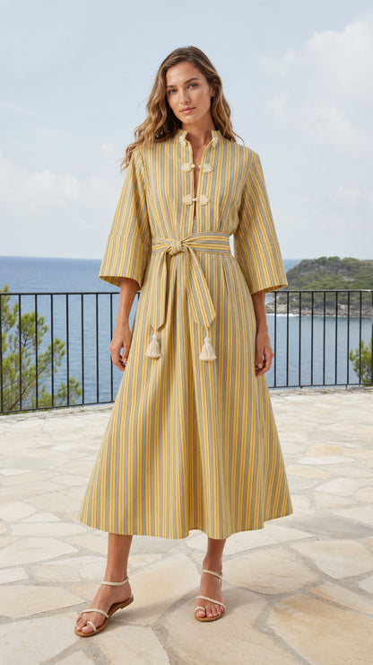 Front view of model wearing yellow striped mandarin collar midi dress with tassel belt