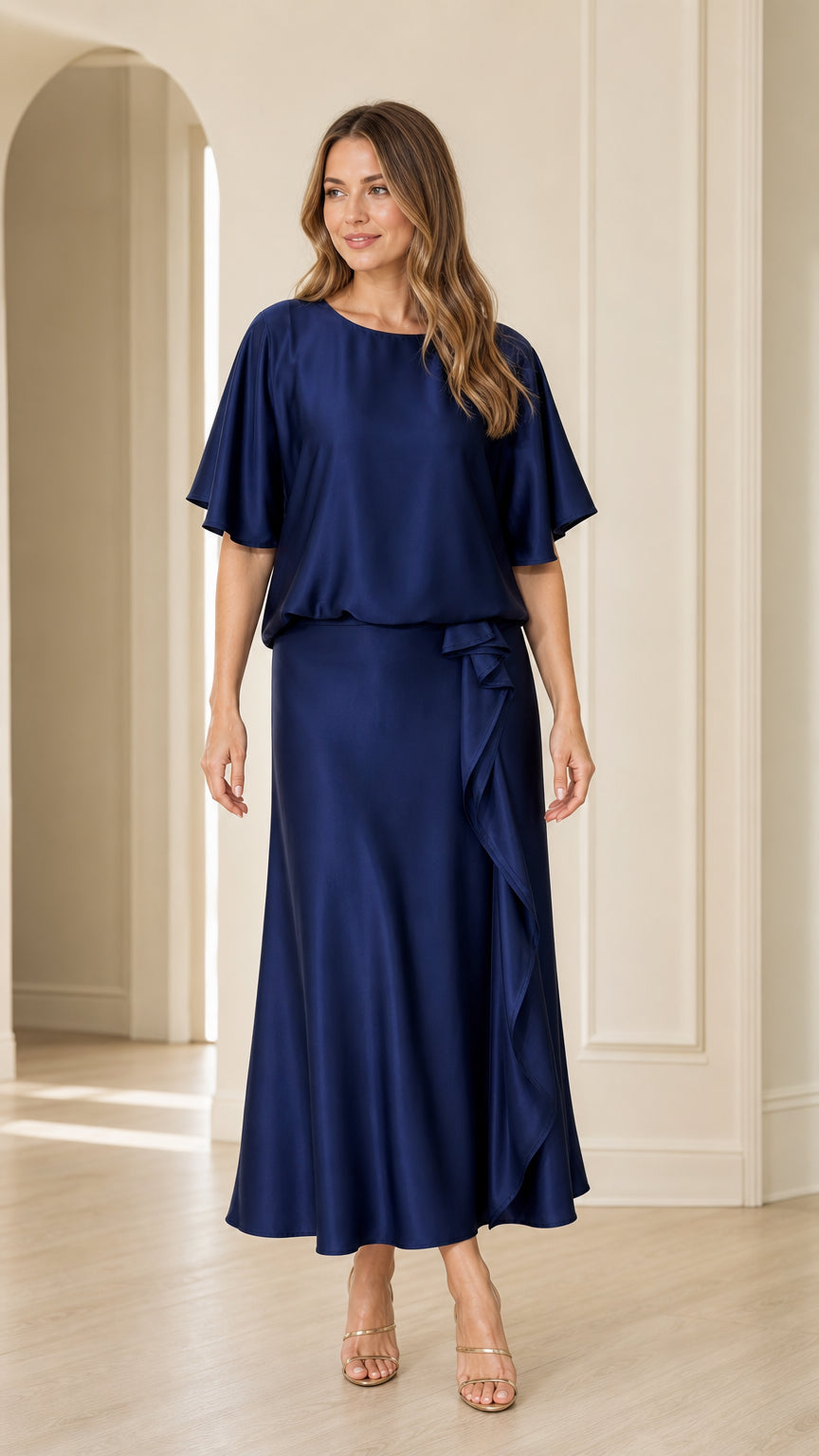 Front view of woman wearing navy blue satin flutter sleeve maxi dress with side ruffle detail