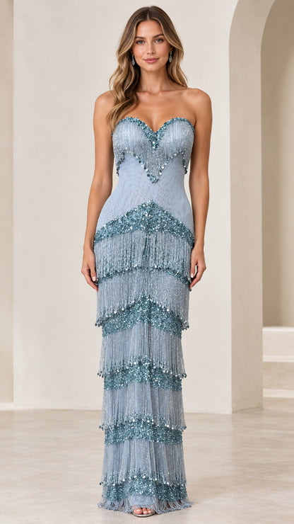 Front view of woman wearing dusty blue strapless beaded fringe maxi evening gown