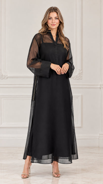 Front view of model wearing black sheer overlay maxi dress with long sleeves
