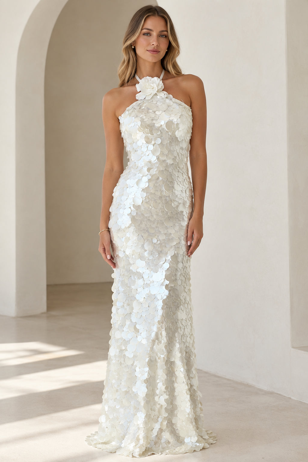 Front full-length view of white floral halter sequin maxi dress