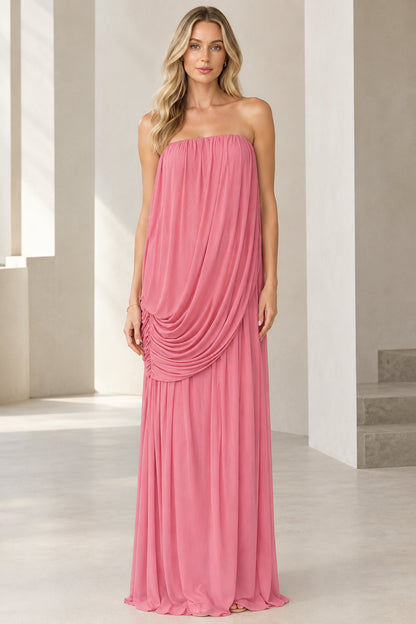 Front full-length view of woman wearing strapless draped maxi dress in rose pink