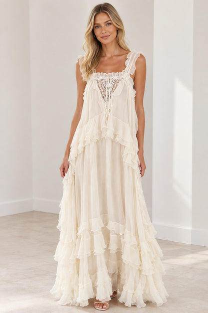 Front view of model wearing cream tiered ruffle lace-up maxi dress