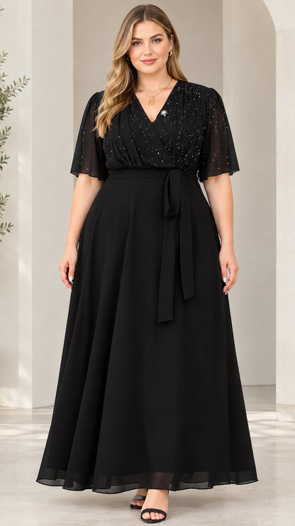 Full front view of model wearing black glitter bodice flutter sleeve chiffon evening maxi dress