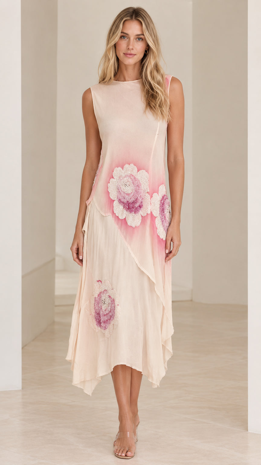 Front view of model wearing Blush Pink sleeveless asymmetrical floral midi dress