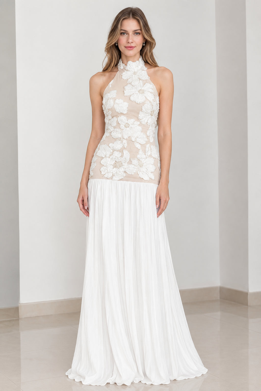 Front view of white floral applique halter neck pleated evening maxi gown