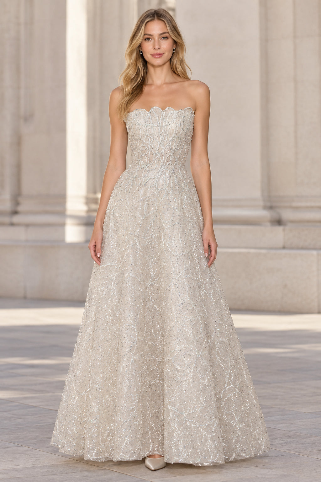 Front view of woman wearing silver strapless scalloped A-line evening gown