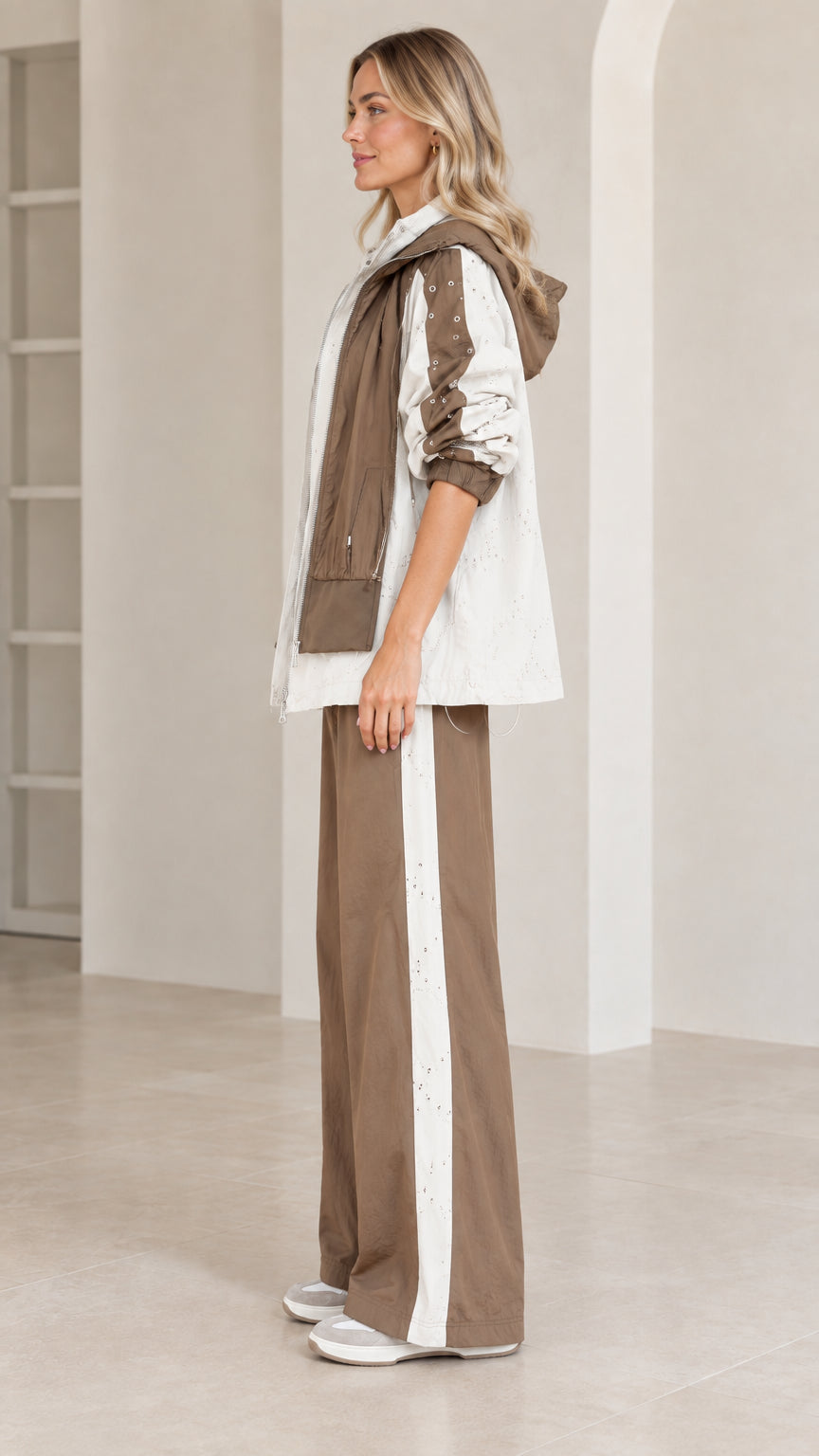 Side profile view of mocha colorblock tracksuit set with side stripe pants