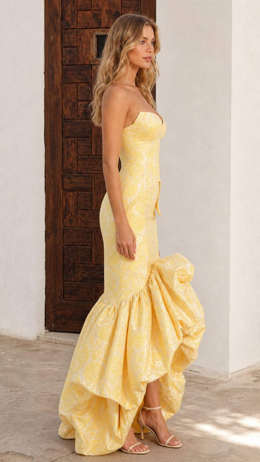 Side profile of butter yellow brocade sweetheart formal dress