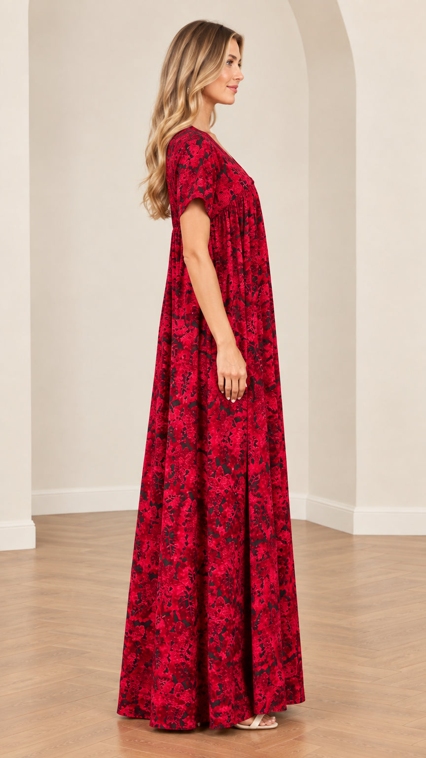 Side profile view of woman wearing relaxed flowy red floral maxi dress