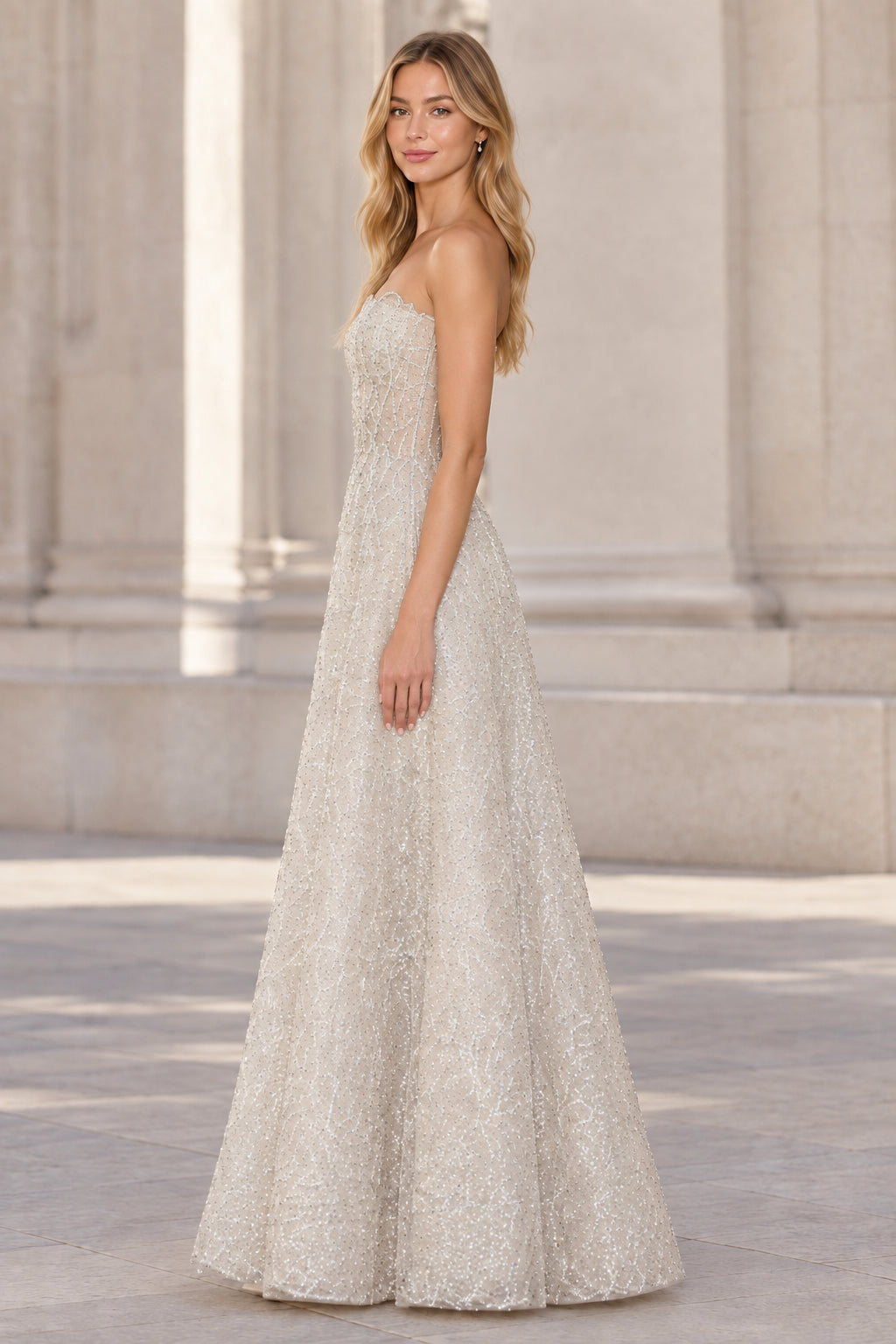 Side profile of silver strapless formal evening dress with shimmering embroidery