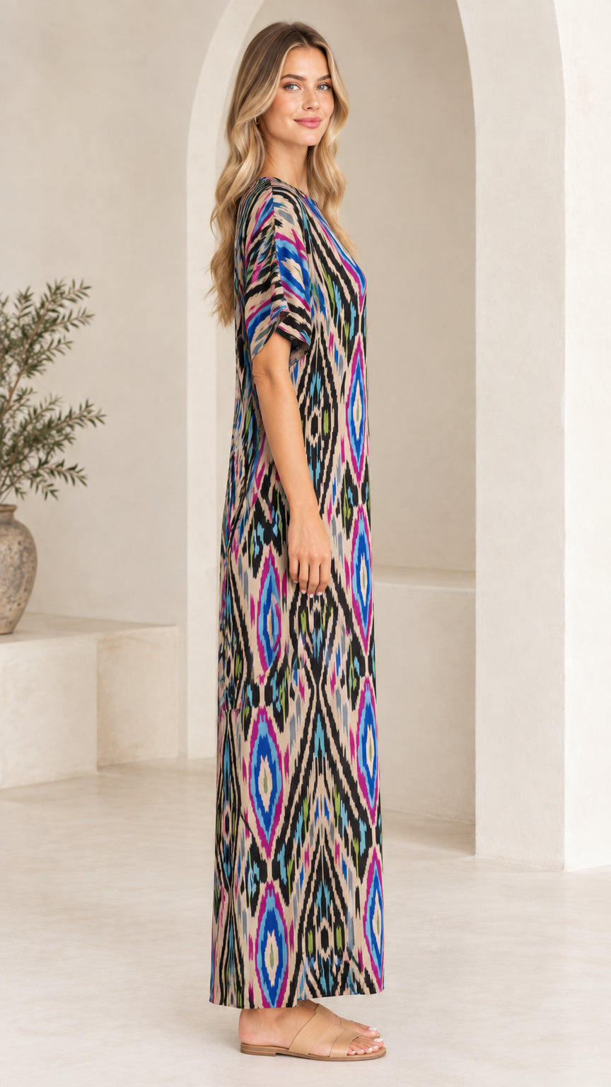 Side profile view of woman in Beige Multi printed maxi dress