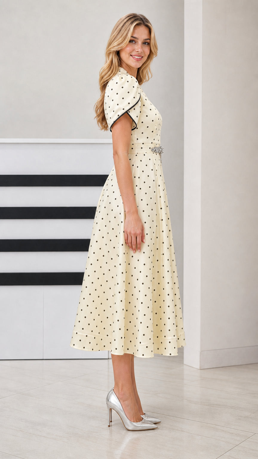 Side profile of woman in Cream polka dot fit-and-flare midi dress with short tulip sleeves