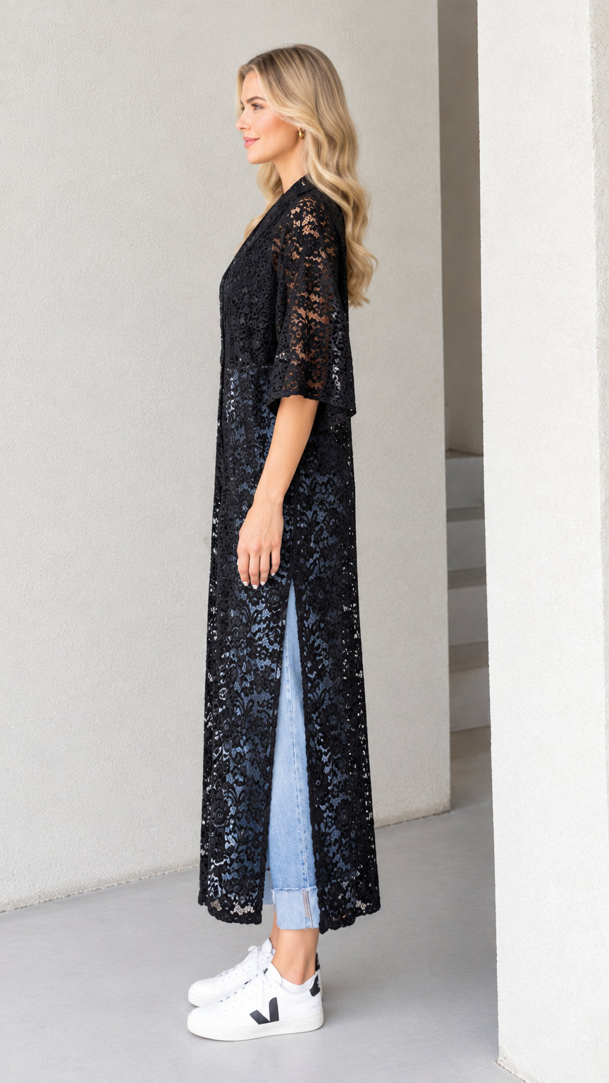 Side profile view of black floral lace maxi duster showing high side slit detail