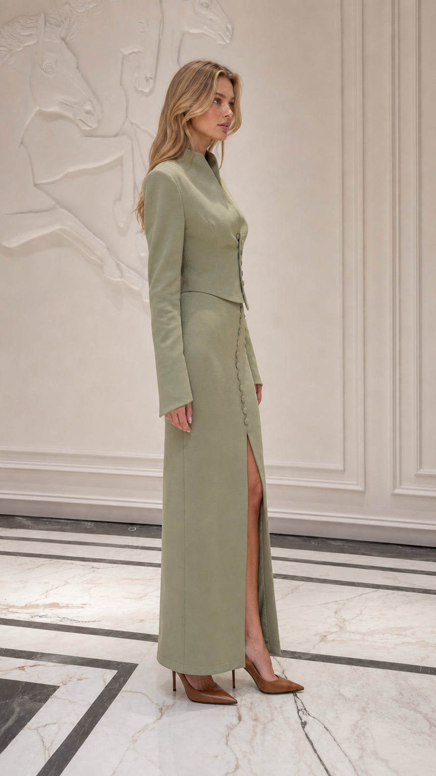 Side profile of model in sage green two-piece set with thigh slit
