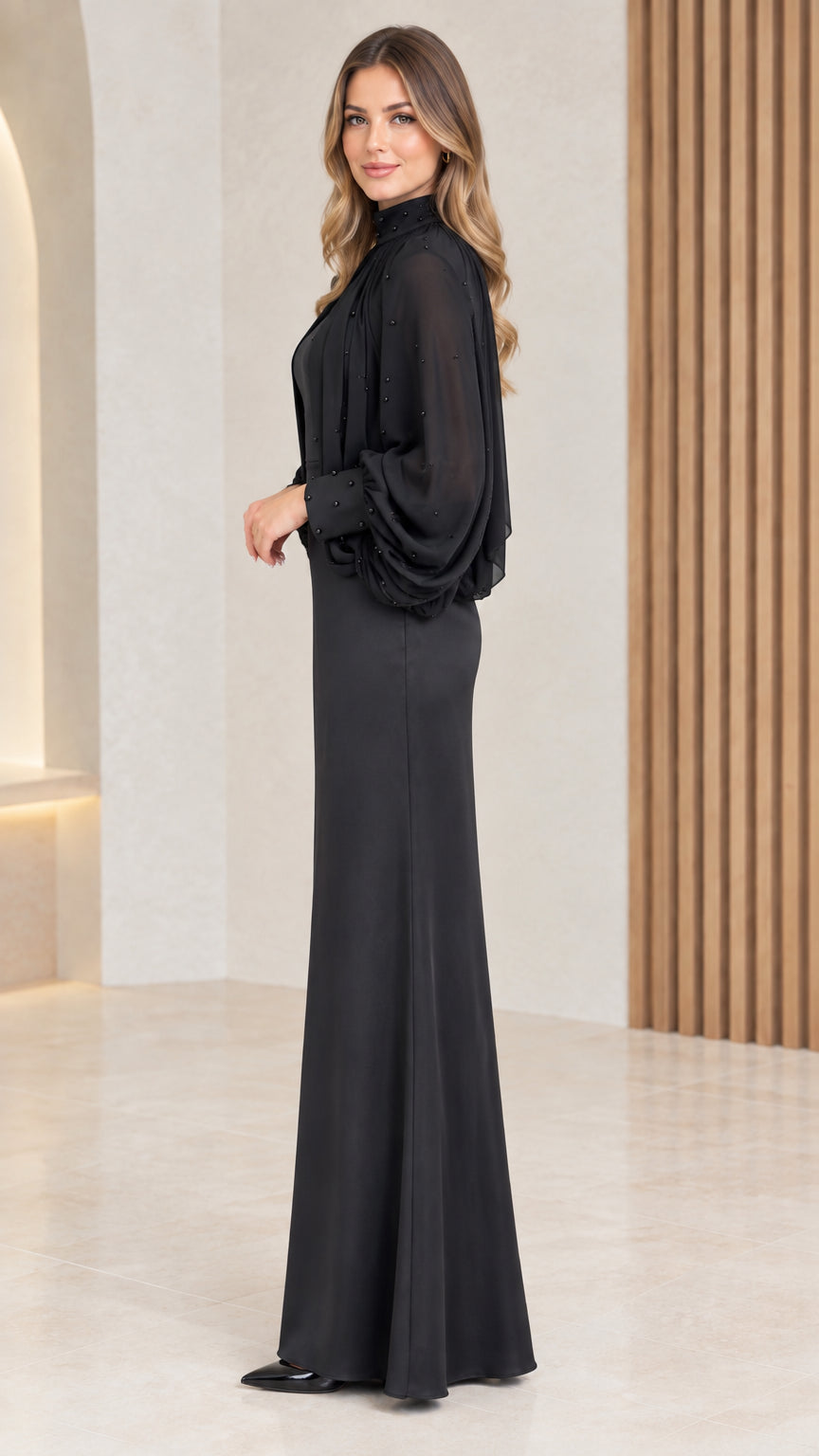 Side view of black formal dress with bishop sleeves and pleated cape