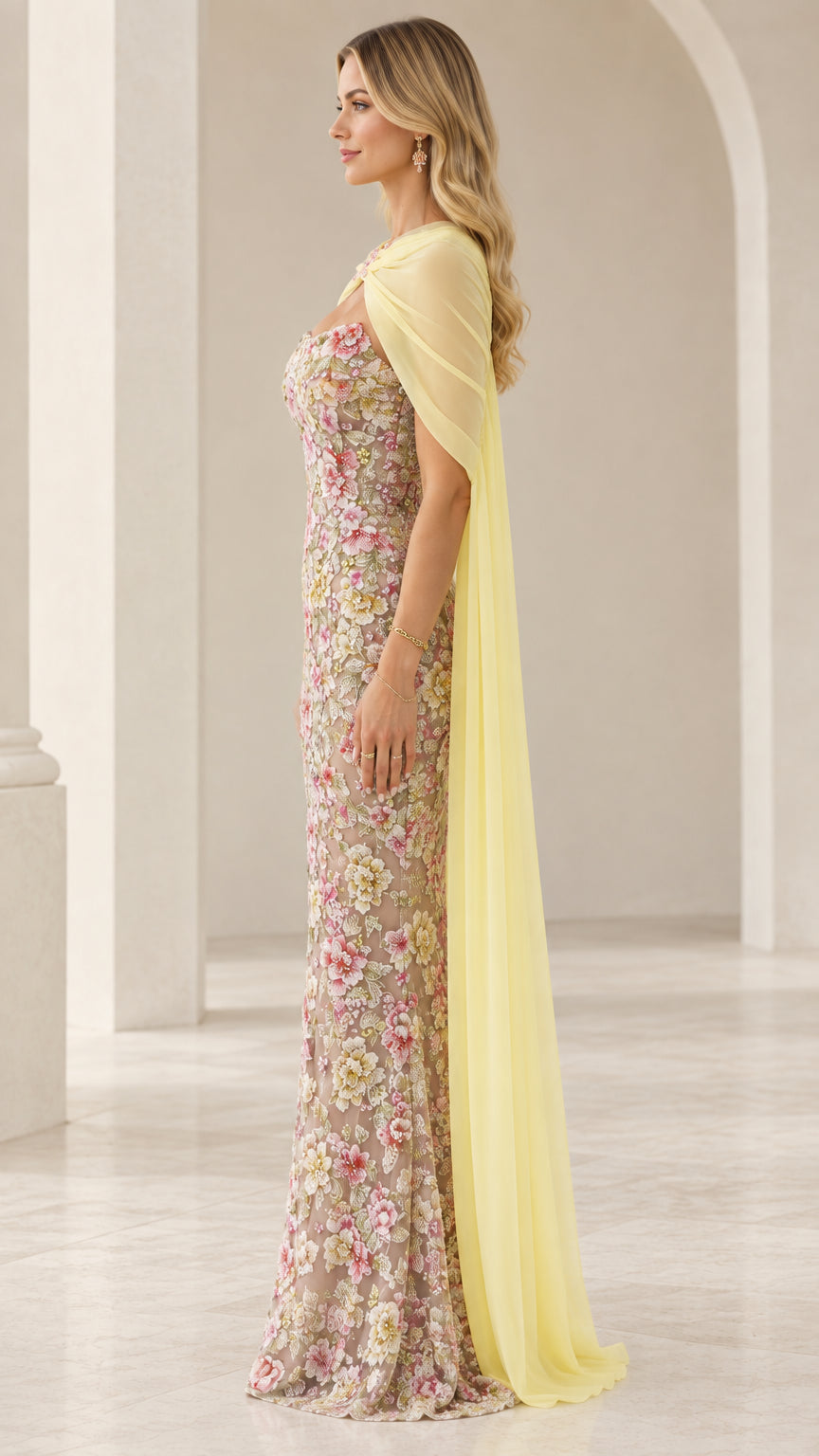 Pastel yellow floral embroidered gown side profile showing capelet drape