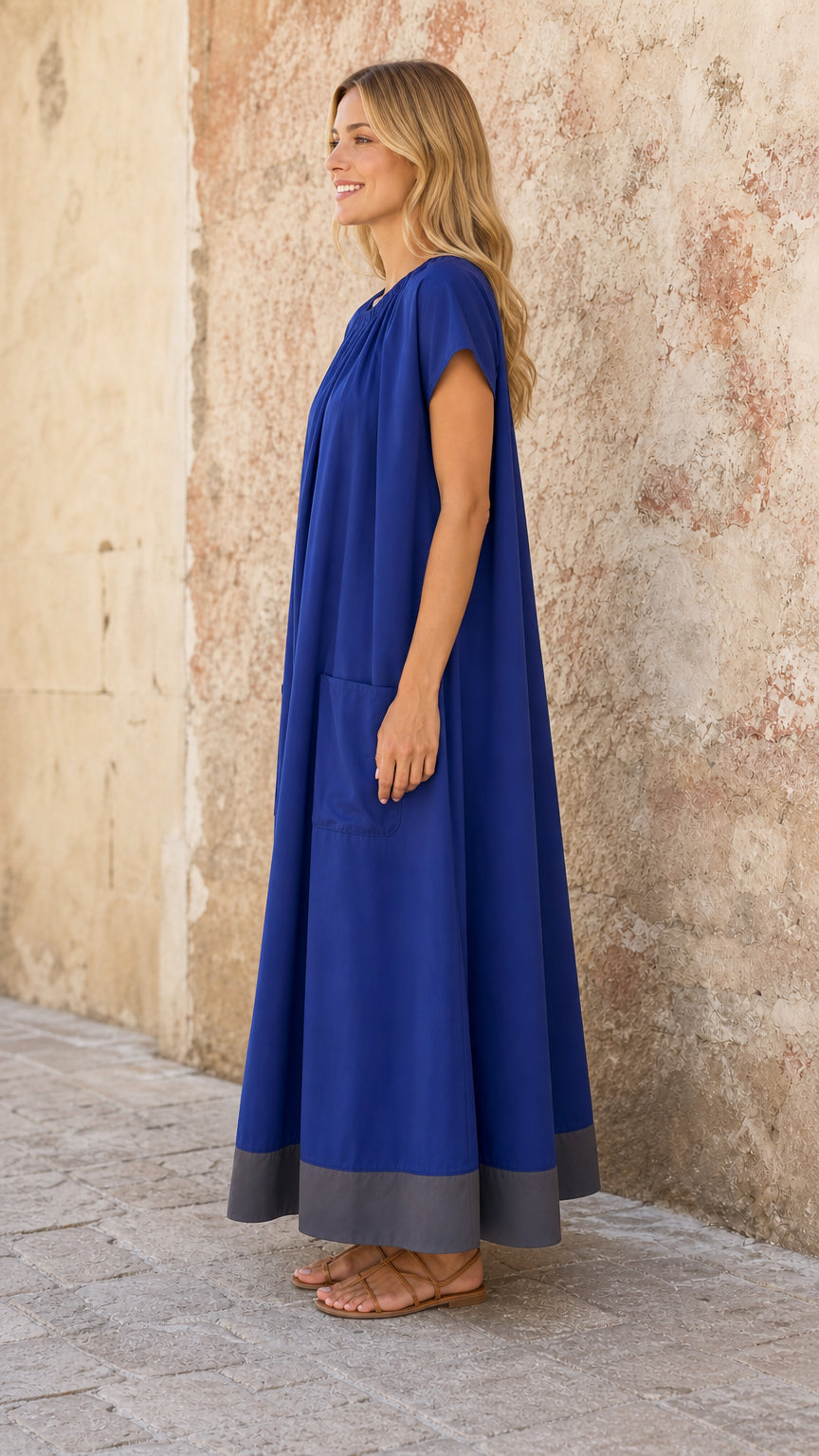 Side profile of model in Royal Blue flowy caftan maxi dress with pockets