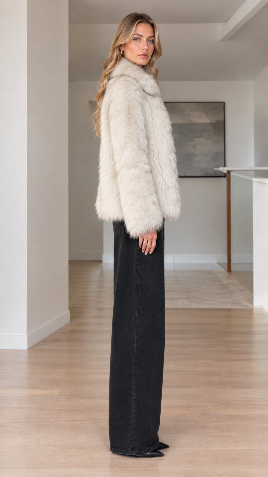 Side profile of model wearing cream faux fur winter jacket
