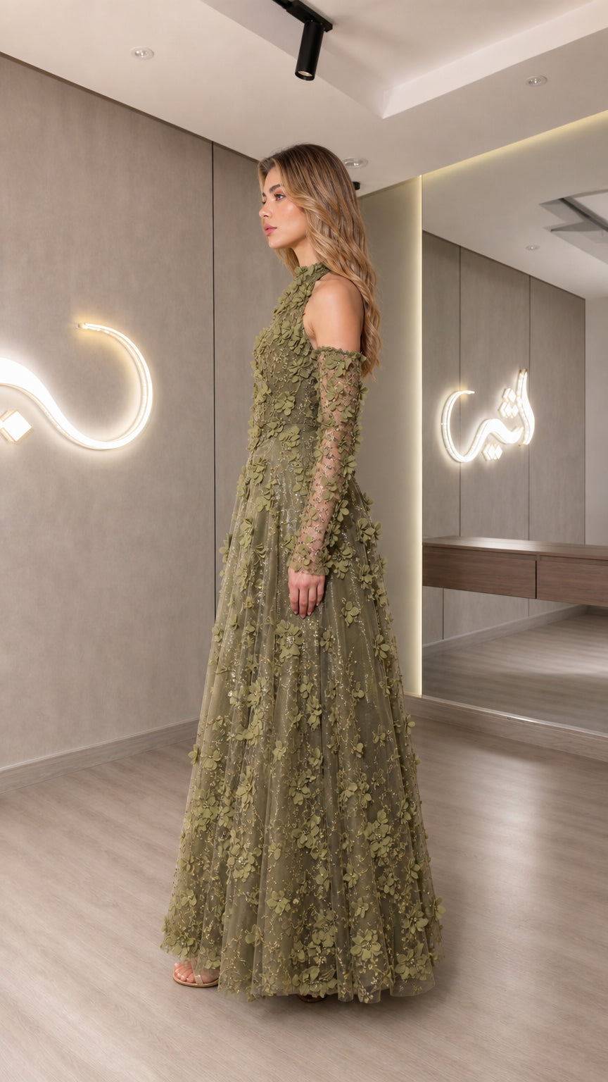 Side profile of model in olive green embroidered maxi gown showcasing elegant silhouette