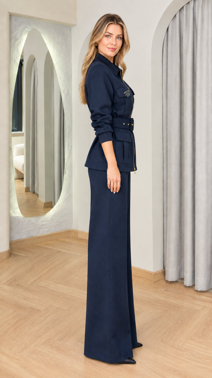 Side profile of woman in navy blue two-piece utility jacket and wide-leg pant set