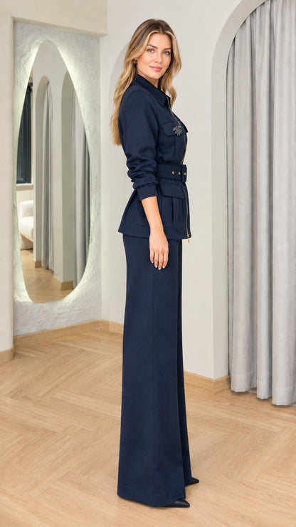 Side profile of woman in navy blue two-piece utility jacket and wide-leg pant set