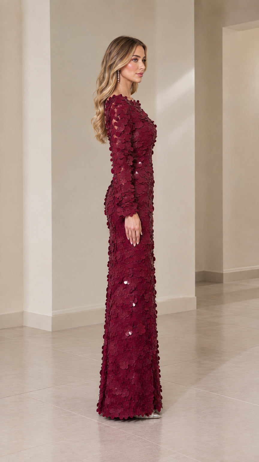 Side profile view of burgundy 3D floral textured evening gown