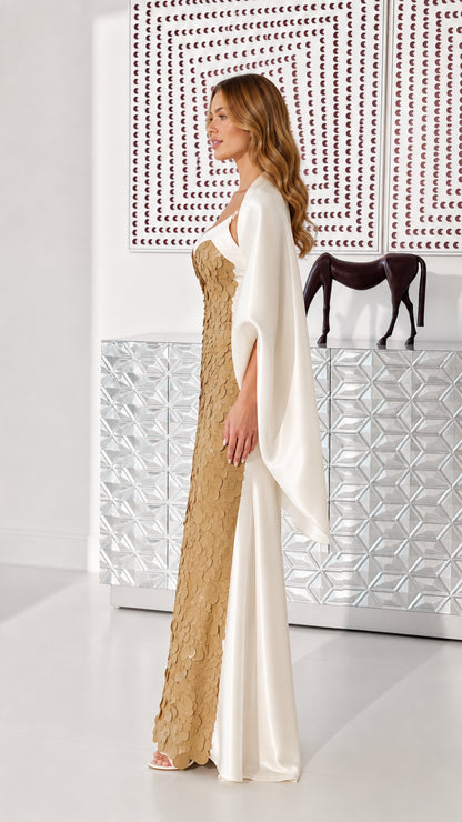 Side profile view of gold sequin evening gown with cascading satin shawl