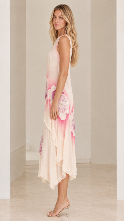 Side angle view of Blush Pink tiered handkerchief hem midi dress