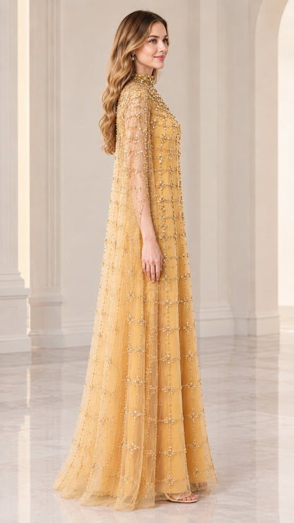 Side full view of woman wearing gold floor-length cape gown