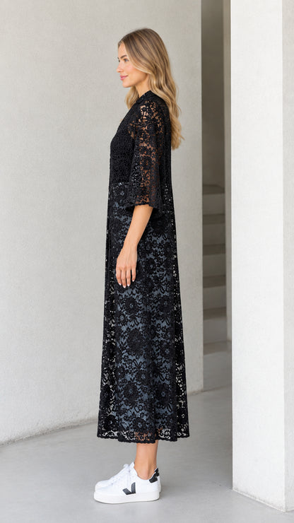 Side profile of black floral lace longline kimono dress paired with white sneakers