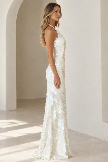 Side profile of white halter sequin evening gown