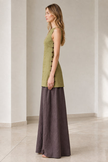 Side profile of model wearing olive green longline tunic and fluid dark wide-leg trousers