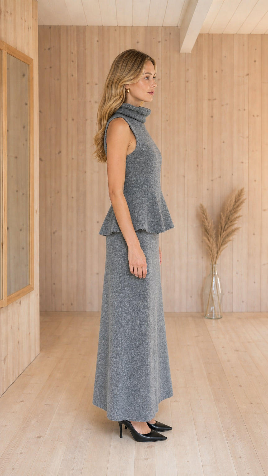 Side profile view of Heather Grey sleeveless peplum top and maxi skirt set