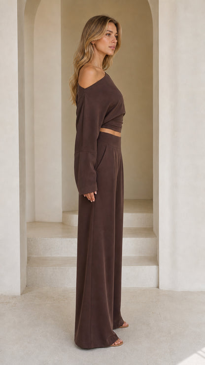 Side profile view of chocolate brown two-piece matching crop top and wide-leg trousers
