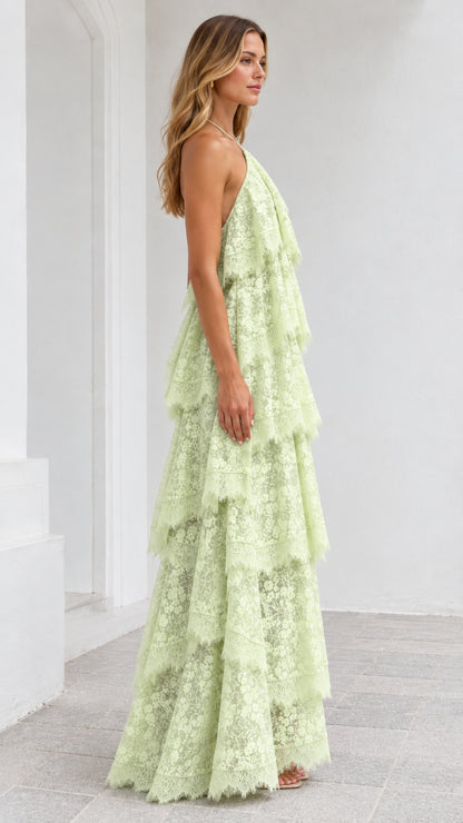 Side view of model posing in Mint Green tiered lace halter dress