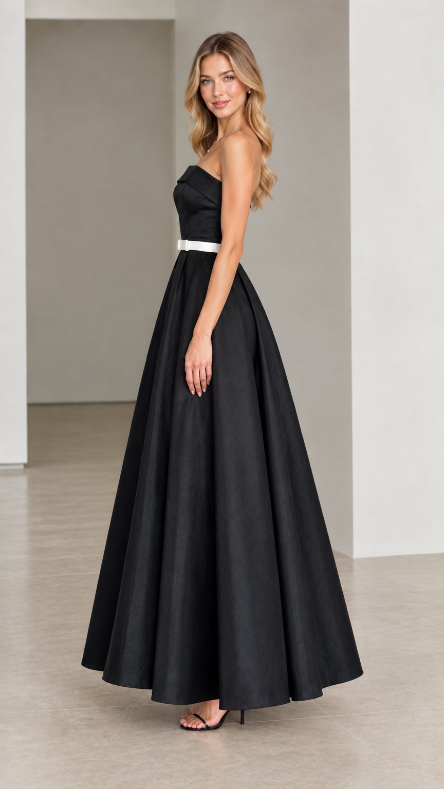 Side profile of strapless black satin floor-length evening dress