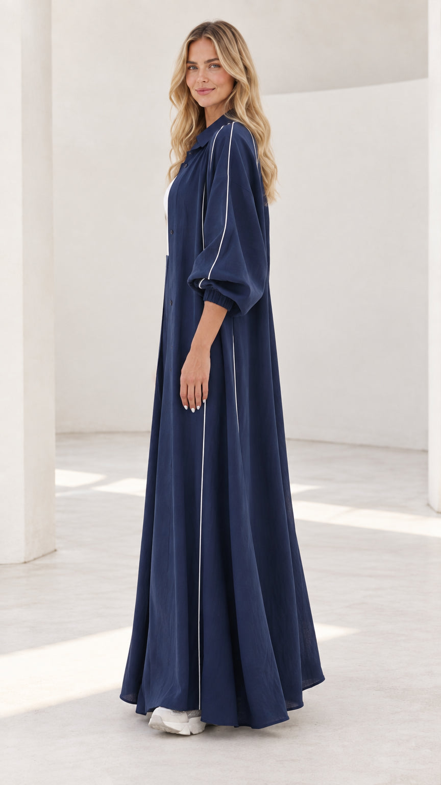 Side profile of navy blue longline duster coat and wide-leg trousers set
