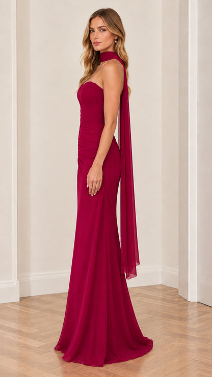 Side angle of berry red strapless evening dress showing draped silhouette
