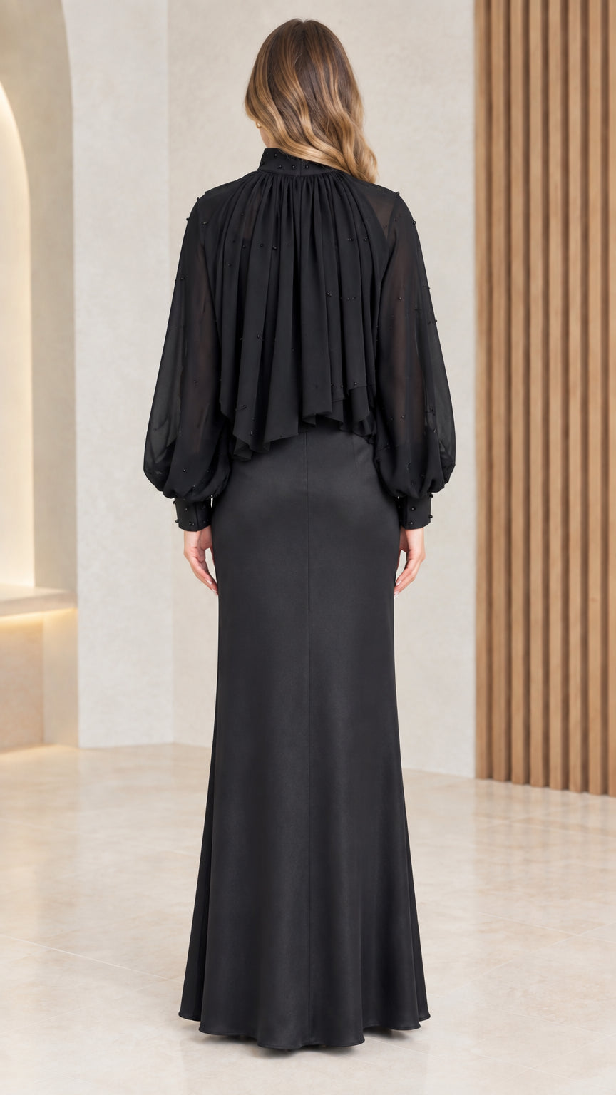 Back view of black maxi gown showing pleated cape drape
