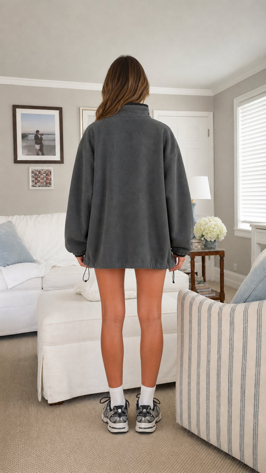 Back view of model wearing charcoal grey oversized half-zip fleece sweatshirt