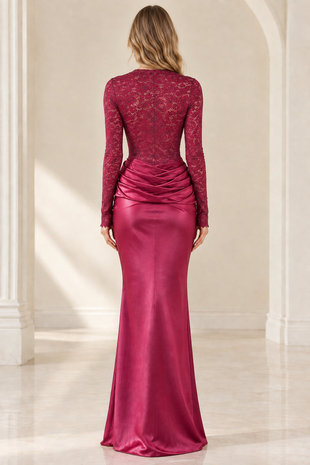 Back view of model in burgundy sheer lace back and draped satin mermaid dress